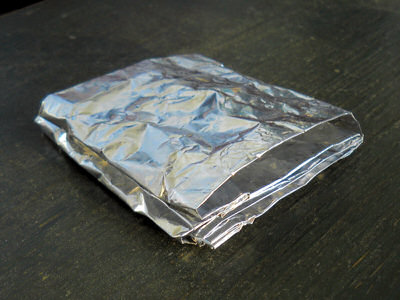 Folded-up aluminium foil used as a windshield while cooking