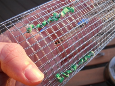 The hardware cloth formed into a cylinder and tied in place with twisty ties