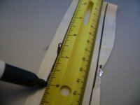 Mark a line along the long side of the sheet metal using a ruler