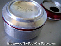 The completed snuffer placed on top of a soda can stove