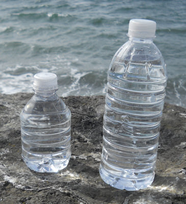Two water bottles repurposed as fuel bottles now filled with denatured alcohol