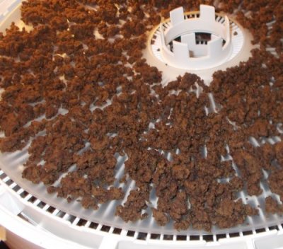 Ground beef in the dehydrator after it has been dehydrated